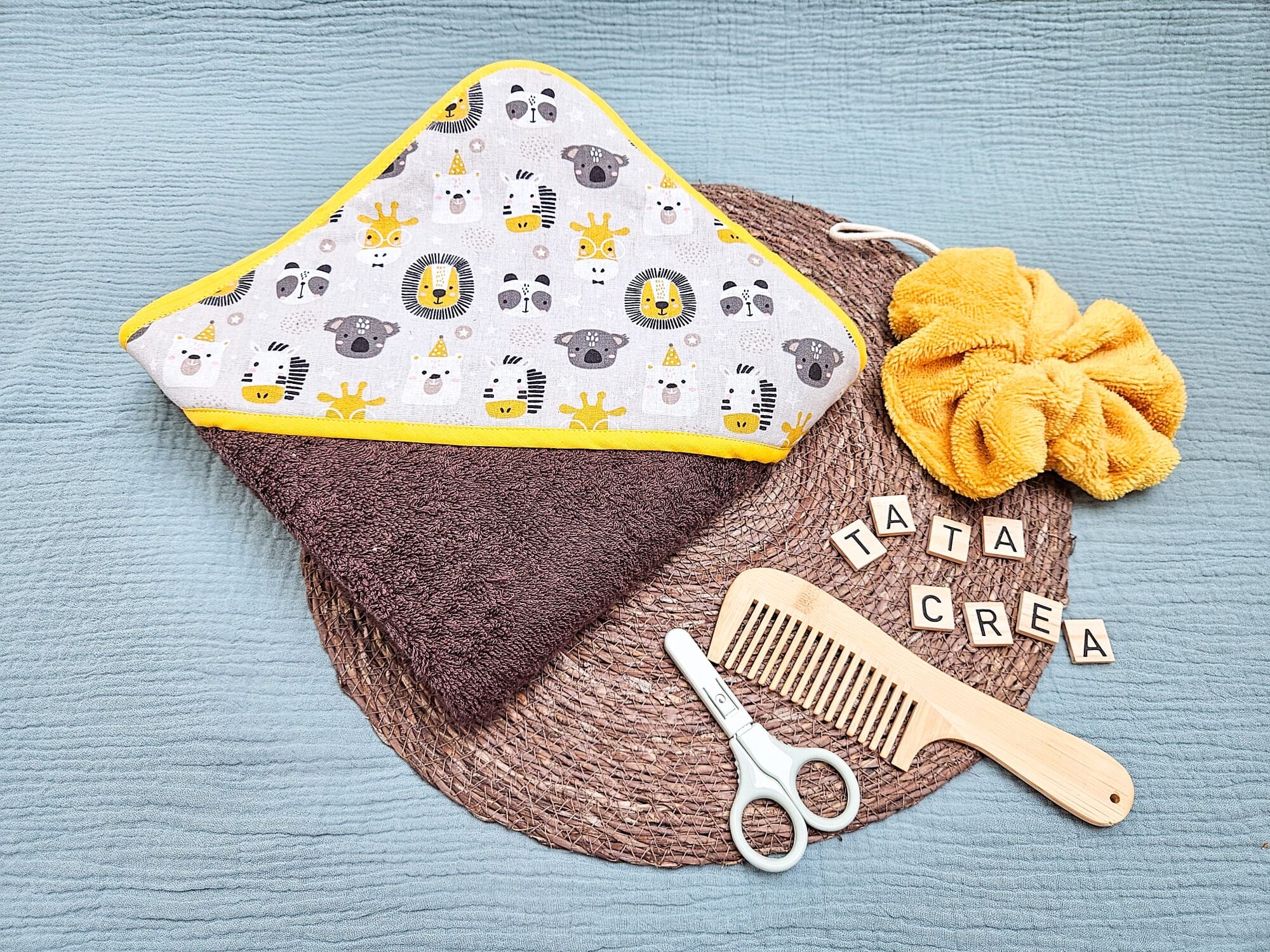 Cape de bain grand format - modèle tata créa. Coton à motifs "savane festive", biais jaune, éponge marron foncée, en attente de personnalisation.